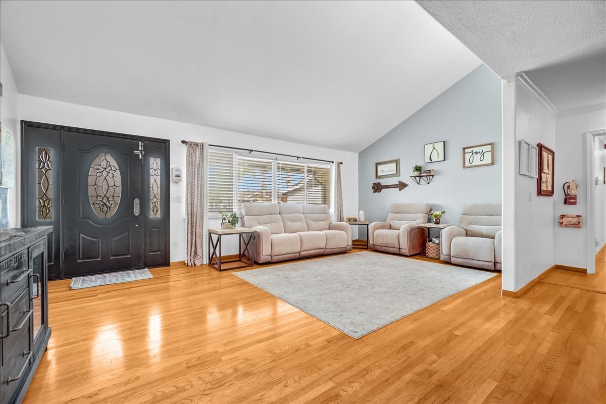 Living room with wood floors and stained glass door at Blessings Senior Care South Birchleaf, Anaheim CA