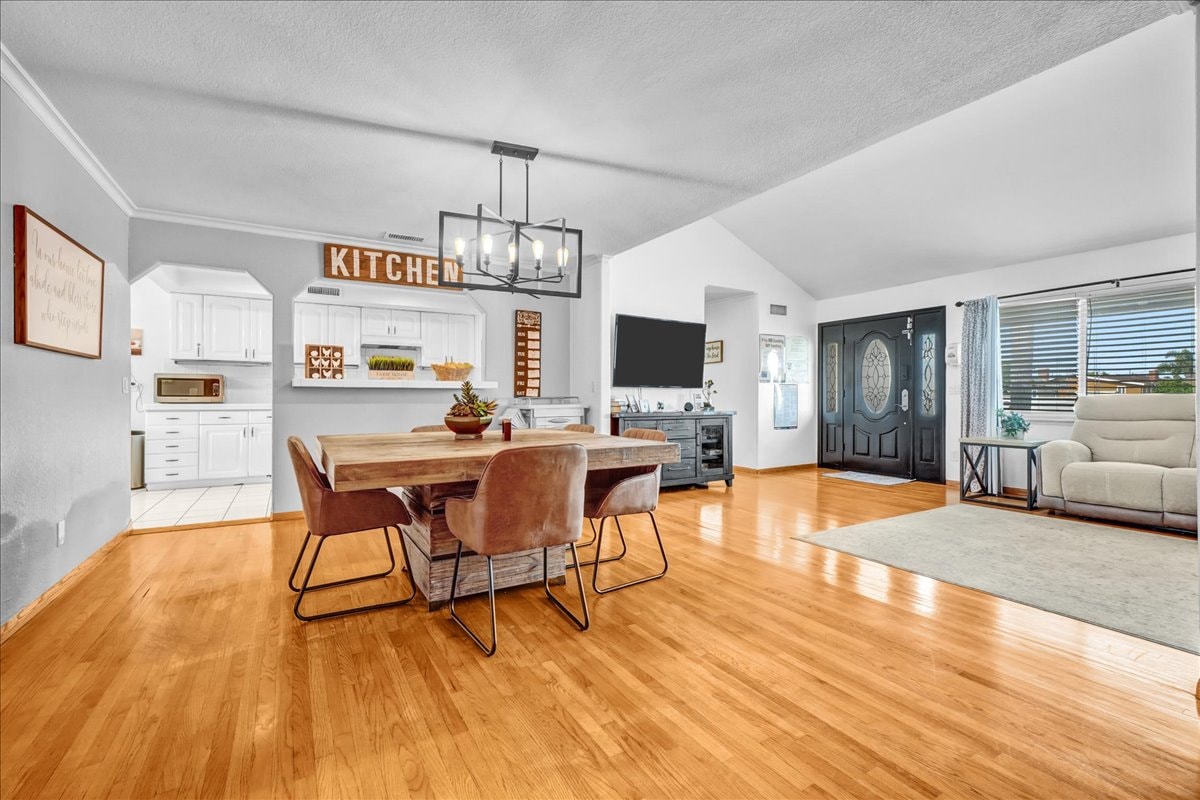 Open dining and living area with chandelier at Blessings Senior Care South Birchleaf, 724 S. Birchleaf Anaheim CA